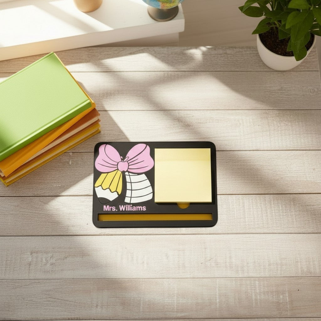 Xpress It Graphics black desk organizer with pink bow, pencil, apple design, yellow sticky note holder, and photo frame with children.