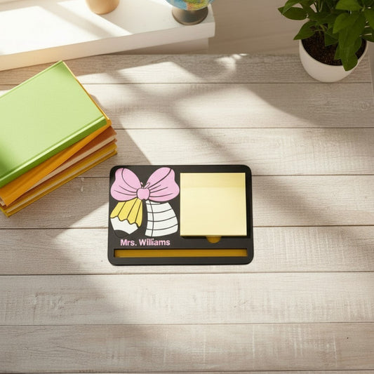 Xpress It Graphics black desk organizer with pink bow, pencil, apple design, yellow sticky note holder, and photo frame with children.